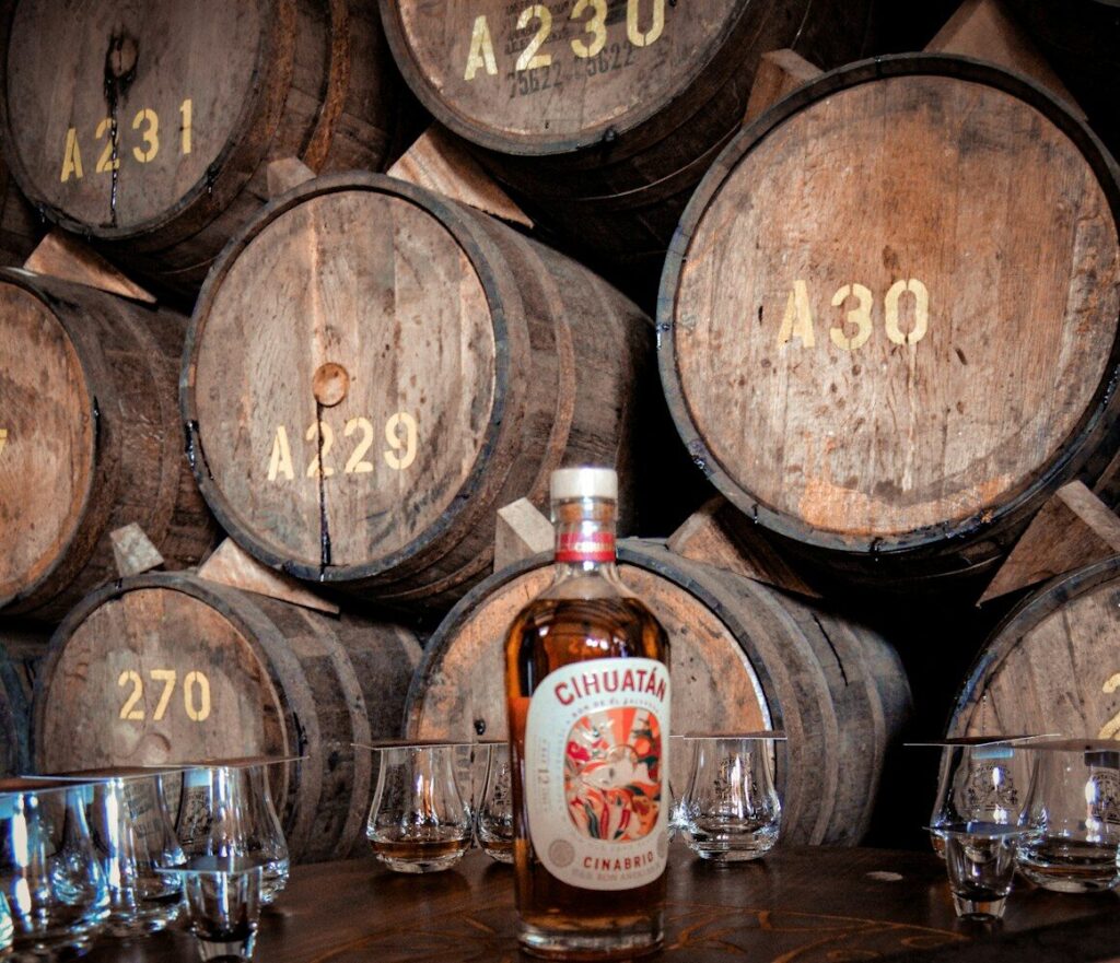 Rutas de ron en el Caribe: guía para 2026 a bottle of whisky sitting on top of a wooden table