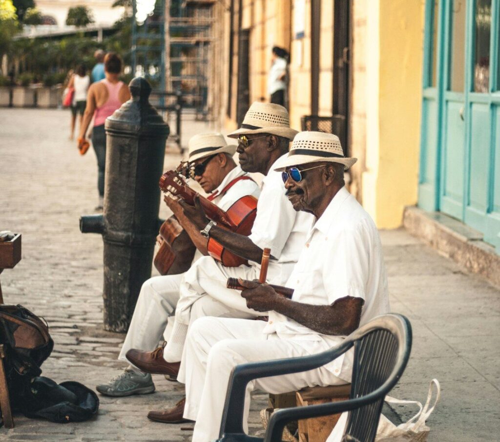 El son cubano y su impacto en la salsa caribeña man playing acoustic guitar while sitting on bench